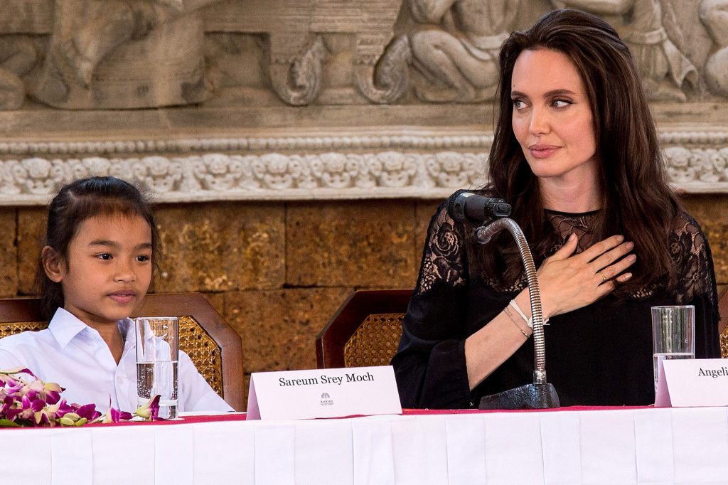 SIEM REAP, CAMBODIA - FEBRUARY 18: Angelina Jolie (right) shows appreciation to actors that were in her last movie "First They Killed My Father" during a press conference set up at the Raffles Grand Hotel D'Angkor on February 18, 2017 in Siem Reap, Cambodia. Angelina Jolie is in Siem Reap for the world premiere of her new movie, "First They Killed my Father," a Netflix-produced adaption of the autobiography by the same name penned by Loung Ung, who lived through the Khmer Rouge regime as a young child. The film will be screened Saturday night in the Angkor Wat temple complex, and released later this year on Netflix. (Photo by Omar Havana/Getty Images)